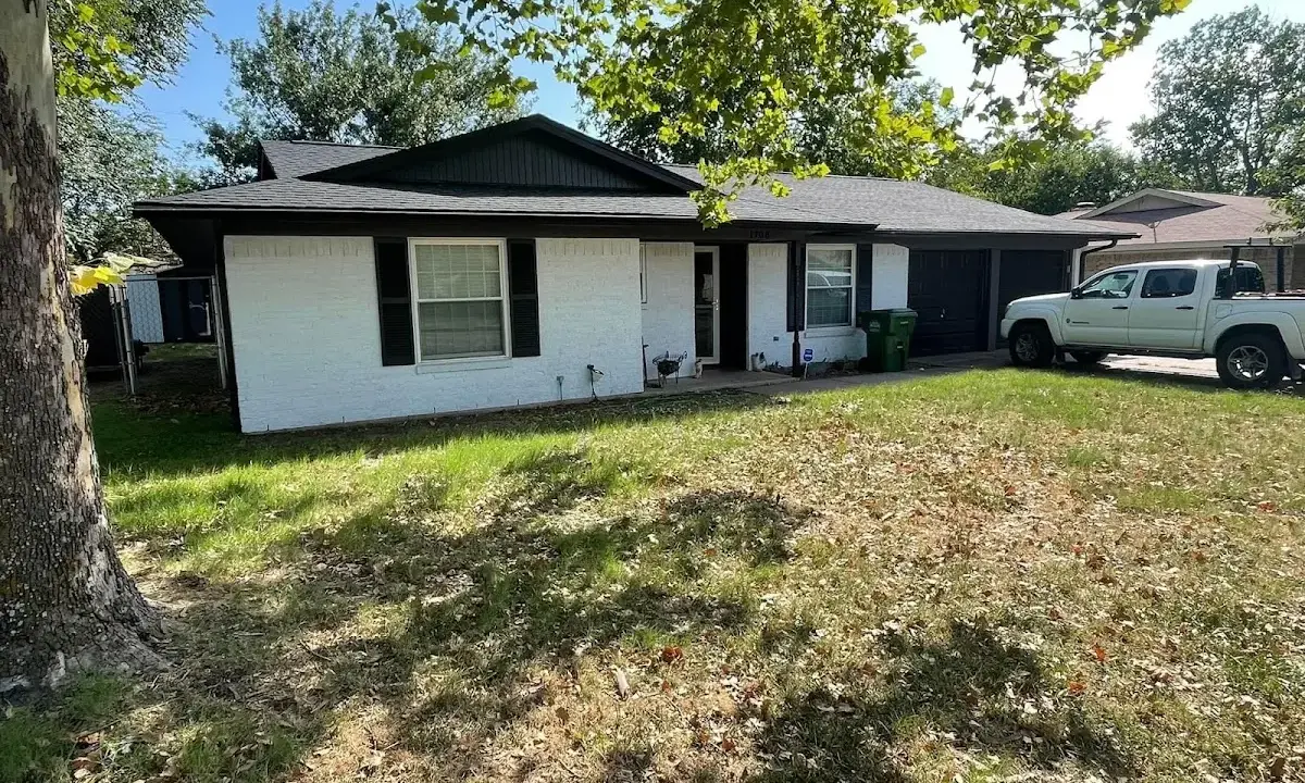 Professional roofing crew working on a residential roof in Slaton